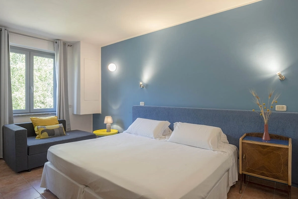 Camera matrimoniale con arredi moderni e vista sul giardino